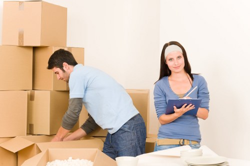 Students arranging storage boxes in a West Kensington flat